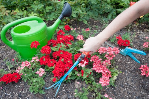 Gardener working safely with tools and protective equipment in a garden